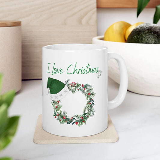 I Love Christmas Mug – Festive Wreath with Green Santa Hat Ceramic Coffee Cup (11oz, 15oz)